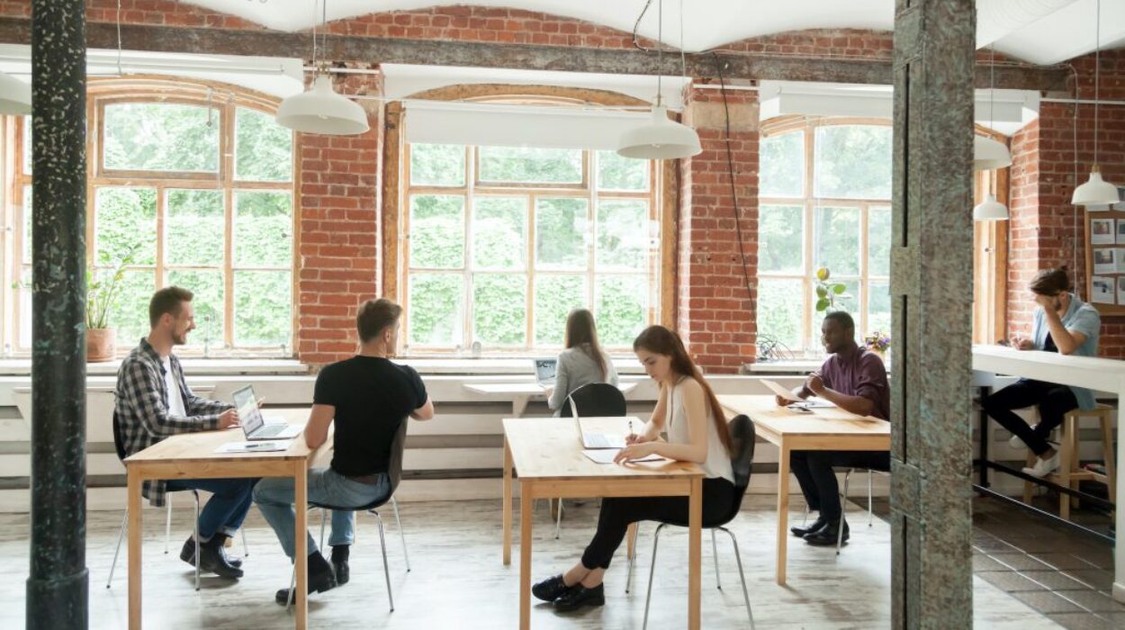 Multiracial people working and talking in modern co-working spac