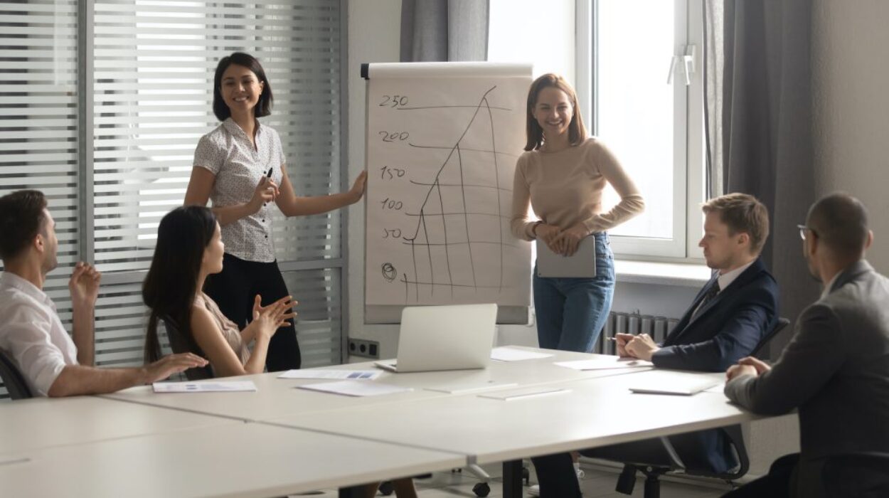 Happy diverse coaches laugh give flip chart presentation at training